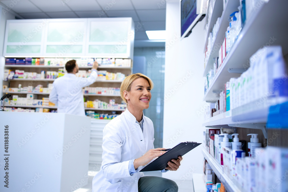 Pharmacists working in pharmacy shop or drugstore. Healthcare and medicine.