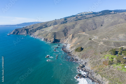 The Pacific Ocean washes against the rugged shoreline of northern California on a beautiful winter day. The scenic Pacific Coast Highway runs along much of the edge of California.