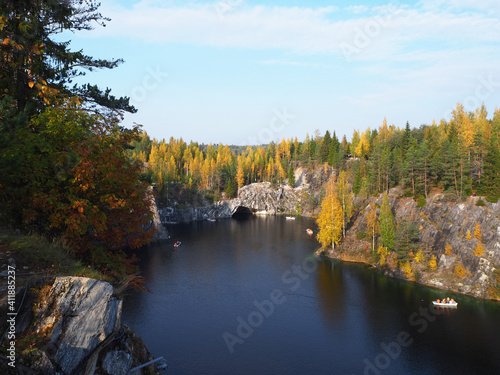 Fototapeta Naklejka Na Ścianę i Meble -  Ruskeala Mountain Park in the autumn. Tourists boating in the Ruskeala Marble Canyon, The Republic of Karelia, Russia