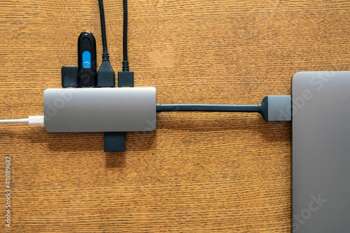 USB hub connected to laptop. Lack of hardware ports on modern laptops concept. Computer technology. Digital background. Internet technology. USB dongle. Transformation of laptop into desktop computer.