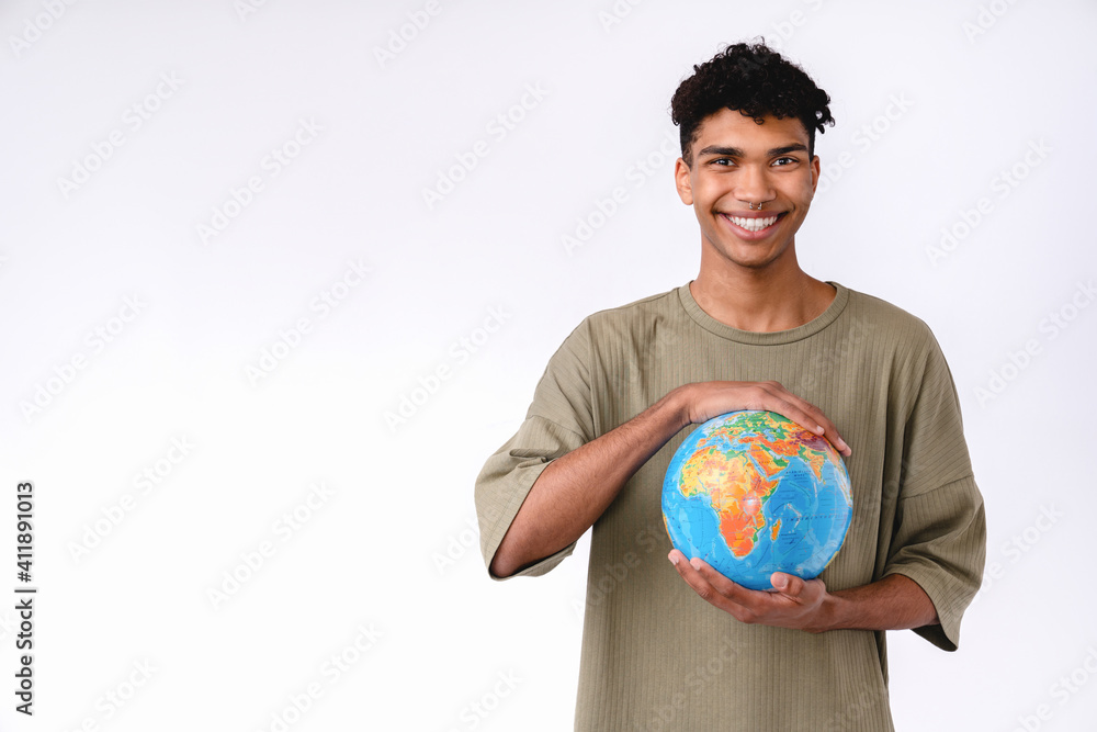 Smiling young african man holding a globe with love isolated over white background Smiling young african man holding a globe with love isolated over white background