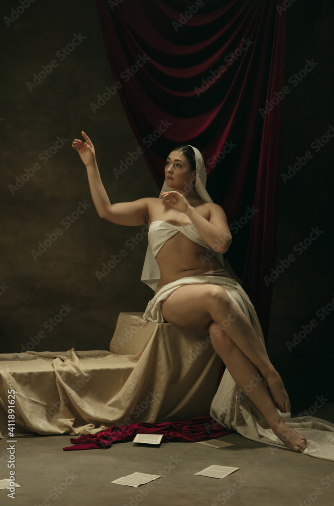 Emotions. Modern remake of classical artwork - young medieval woman on dark background, golden colored. Concept of art, creativity, comparison of eras, history, modernity and renaissance. Emotions. Modern remake of classical artwork - young medieval woman on dark background, golden colored. Concept of art, creativity, comparison of eras, history, modernity and renaissance.
