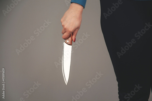 woman hand holding knife in back