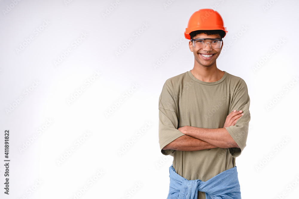 Confident young construction worker in hard hat isolated over white background Confident young construction worker in hard hat isolated over white background