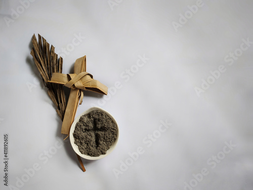 Lent Season,Holy Week and Good Friday Concepts - photo of bowl of ash with cross made of palm leave background. Stock photo. photo