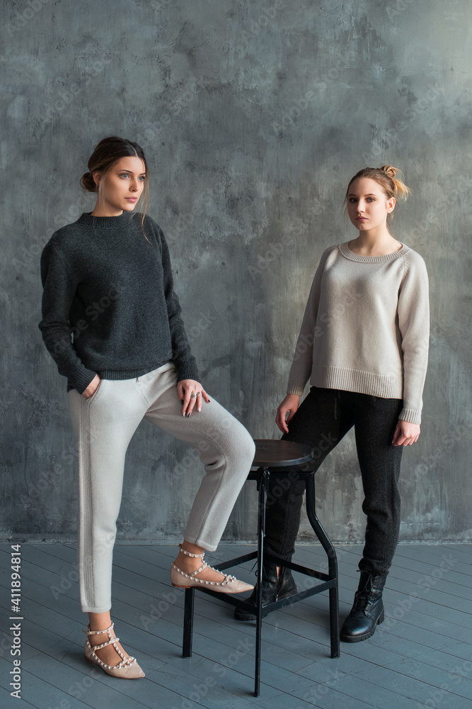 two girls in a gray sweater