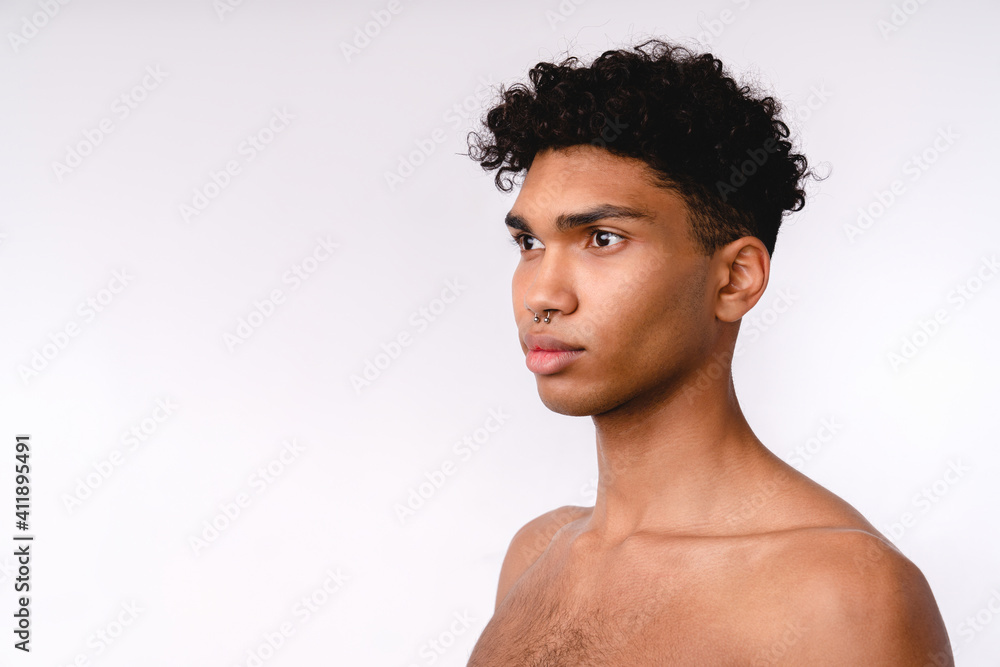 Side view portrait of a handsome young mixed-race shirtless man isolated over white background Side view portrait of a handsome young mixed-race shirtless man isolated over white background