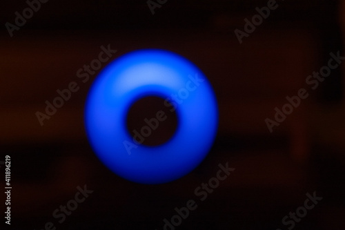 Abstraction, a circle of blue light in the dark.