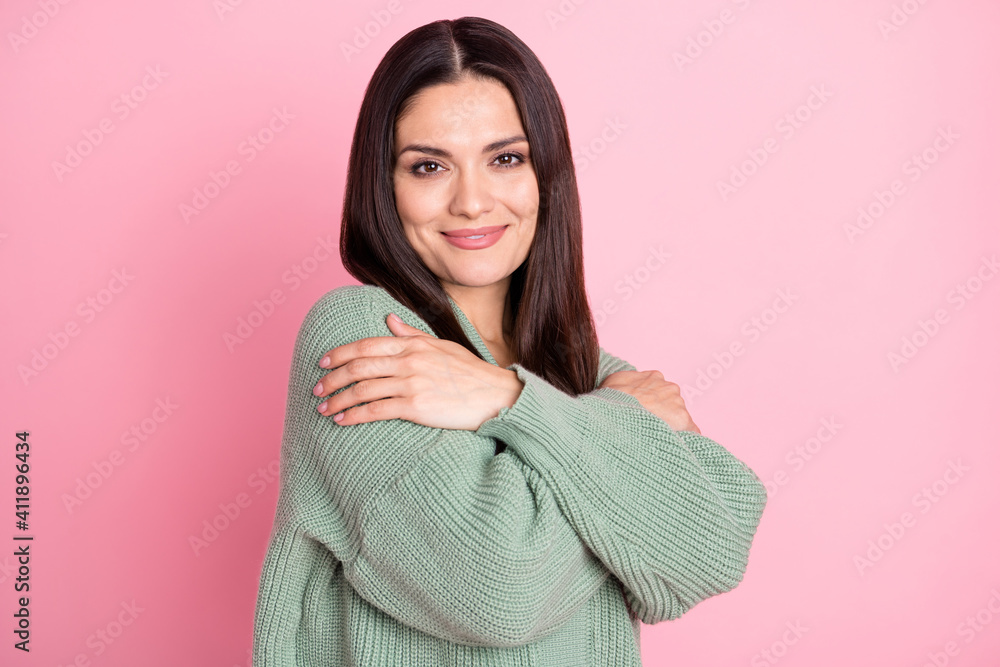 Photo of inspired girl hands hold shoulders look camera wear green cardigan isolated pastel pink color background Photo of inspired girl hands hold shoulders look camera wear green cardigan isolated pastel pink color background