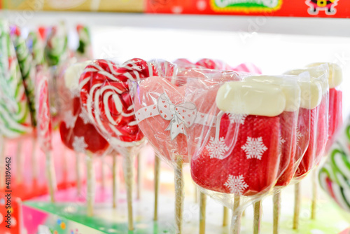 Lollipops in the shape of a heart and a New Year's sock lie on the counter of the store.