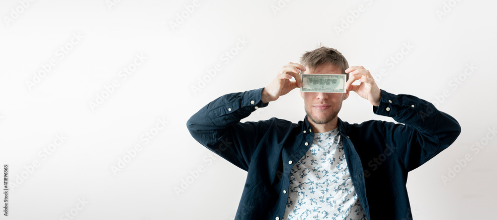 young male person holding a pack of dollar cash currency and cover the face, concept of success earning young male person holding a pack of dollar cash currency and cover the face, concept of success earning