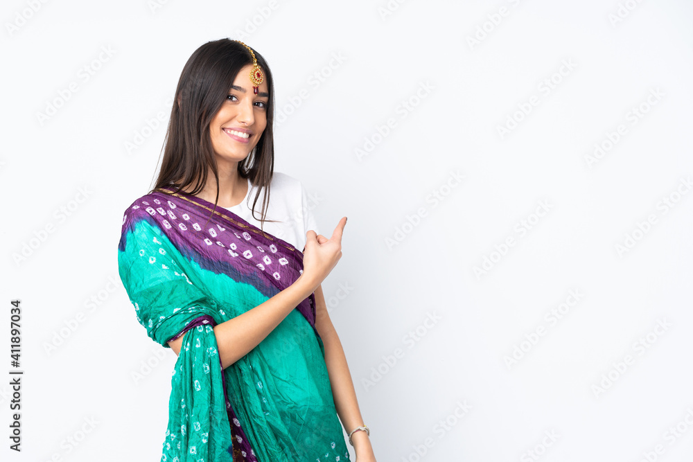 Young Indian woman isolated on white background pointing back Young Indian woman isolated on white background pointing back