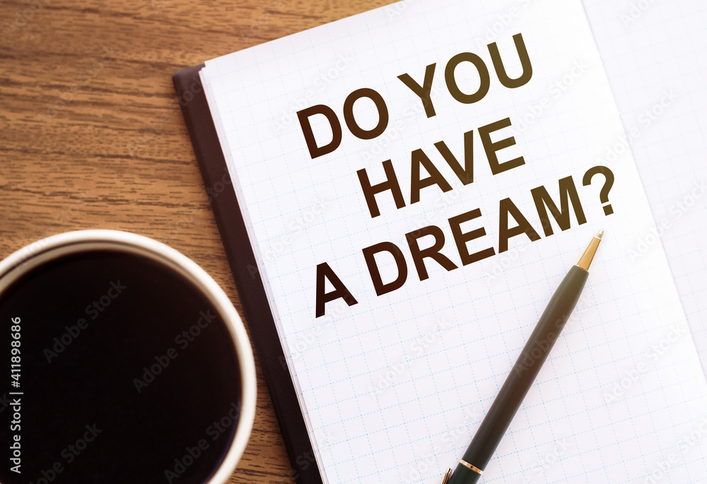 DO YOU HAVE A DREAM? - text on notepad on wooden desk. DO YOU HAVE A DREAM? - text on notepad on wooden desk.