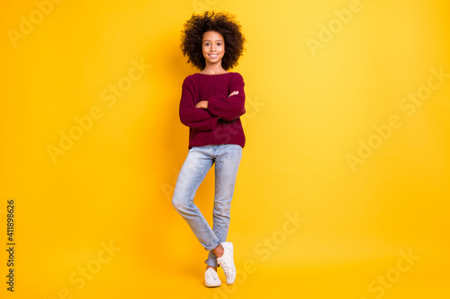 Full size portrait of adorable dark skin pupil folded hands toothy smile wear pullover isolated on yellow color background © deagreez