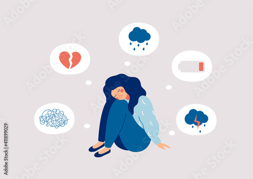 Young woman who suffers from mental health diseases is sitting on the floor. Girl surrounded by symptoms of depression disorder: anxiety, crisis, tears, exhaustion, loss, overworked, tired.