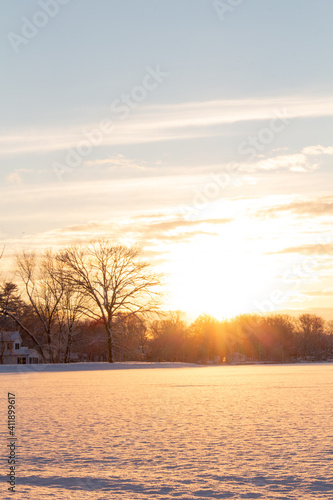 beautiful glowing winter sunset over snow covered lake © Kevin