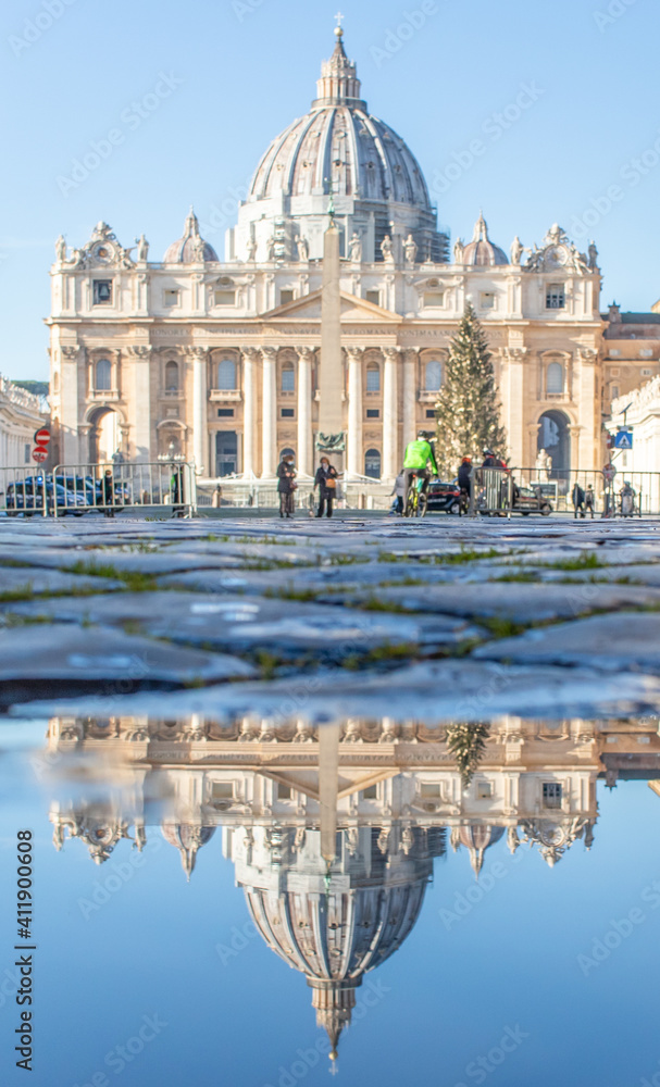 Rome, Italy - in Winter time, frequent rain showers create pools in which the wonderful Old Town of Rome reflects like in a mirror. Here in particular the St. Peter's Basilica 