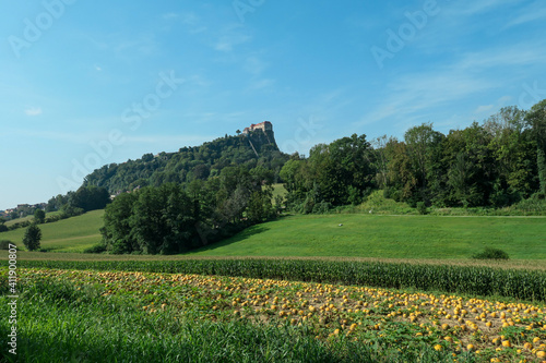 Riegersburg castle in Austria towering above the area. There are pumpkins ripening on the field in front. Clear blue sky above the castle. The massive fortress was build on the rock. Middle ages photo