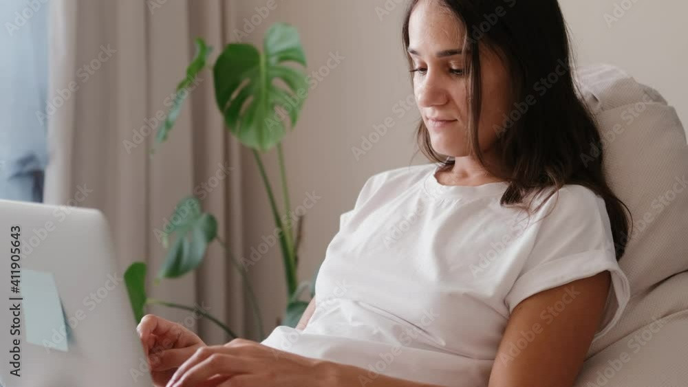 Young woman working on laptop from home. Lady student studying using computer Young woman working on laptop from home. Lady student studying using computer