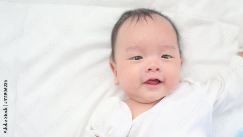 2 months Baby boy lying on a white bed, Family morning at home,Children hygiene. 2 months Baby boy lying on a white bed, Family morning at home,Children hygiene.