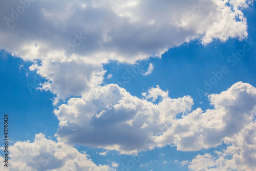 Sunny summer sky with large cumulus clouds.