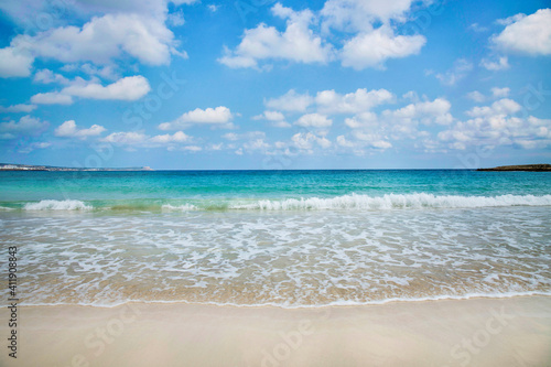 Landmark sea tourist attraction Makronisos bay with golden sand beach at Ayia Napa in Cyprus. Swimming in turquoise sea water, relaxing and sunbathing