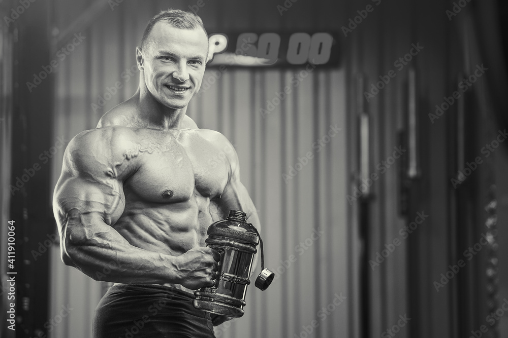 Bodybuilder with protein powder supplements jar Bodybuilder with protein powder supplements jar