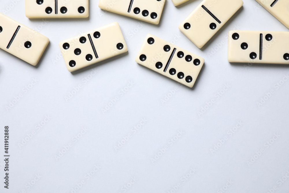 Classic domino tiles on white background, flat lay. Space for text Classic domino tiles on white background, flat lay. Space for text