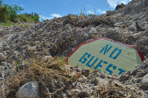 Old sign thrown up near beach shore
