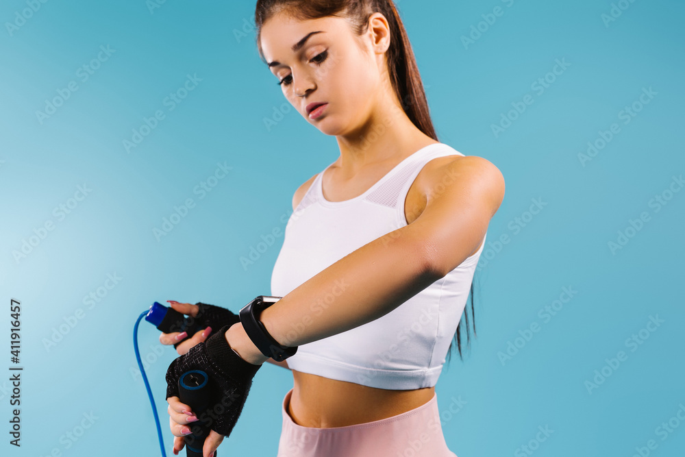 girl using a fitness watch counts the calories burned after