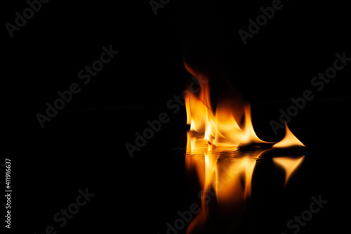 fire flame with reflection in the glass on a black background