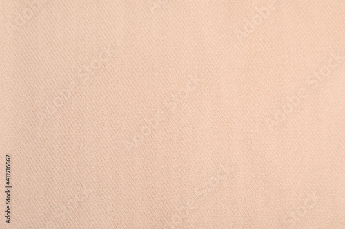 Beige soft cashmere fabric as background, closeup