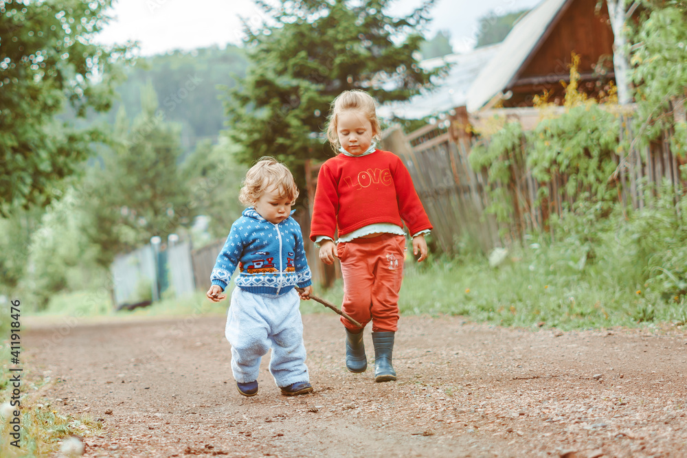 sister and brother walking down the street sister and brother walking down the street