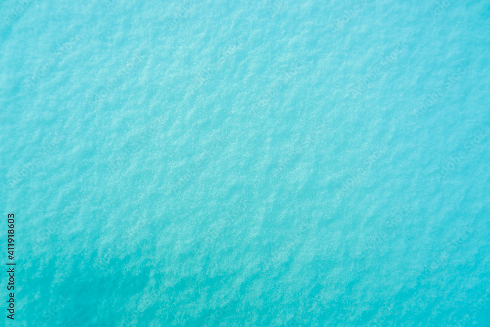 Colored snow as a background. Turquoise background.