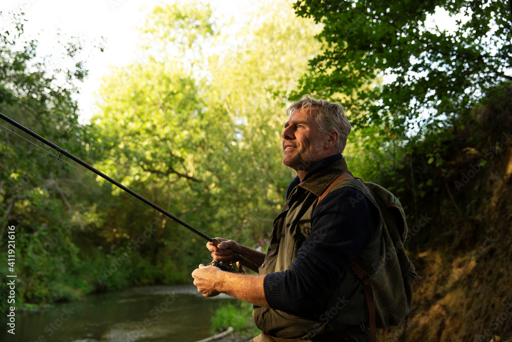 Serene man fly fishing at river Serene man fly fishing at river