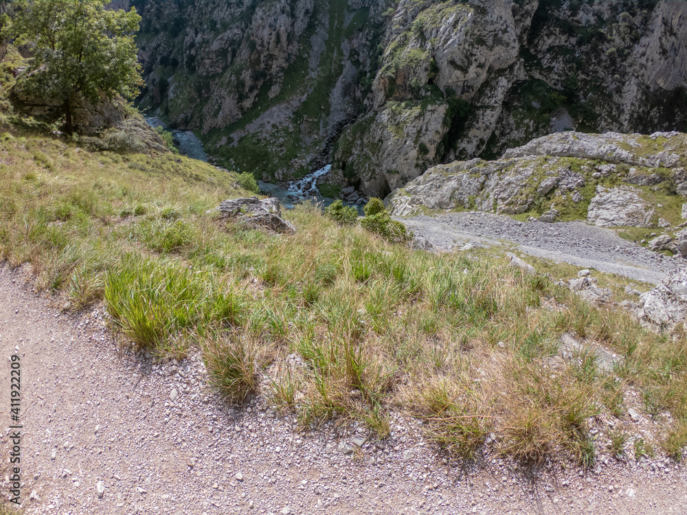 The Cares Route in the heart of Picos de Europa National Park, Cain-Poncebos, Asturias, Spain. Narrow and impressive canyon between cliffs, bridges, caves, footpaths and rocky mountains. The Cares Route in the heart of Picos de Europa National Park, Cain-Poncebos, Asturias, Spain. Narrow and impressive canyon between cliffs, bridges, caves, footpaths and rocky mountains.
