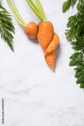 Partial view of an Imperfect carrot on a marble background photo