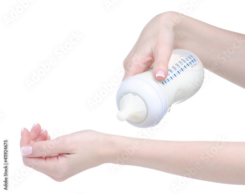 Baby bottle with milk in hand on white background isolation