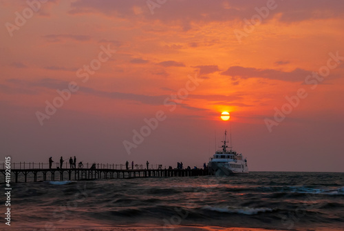 Seascape. Pier against the backdrop of sunset sky with beautiful clouds and sea waves. Anapa. Krasnodar Territory. © Андрей Иванов