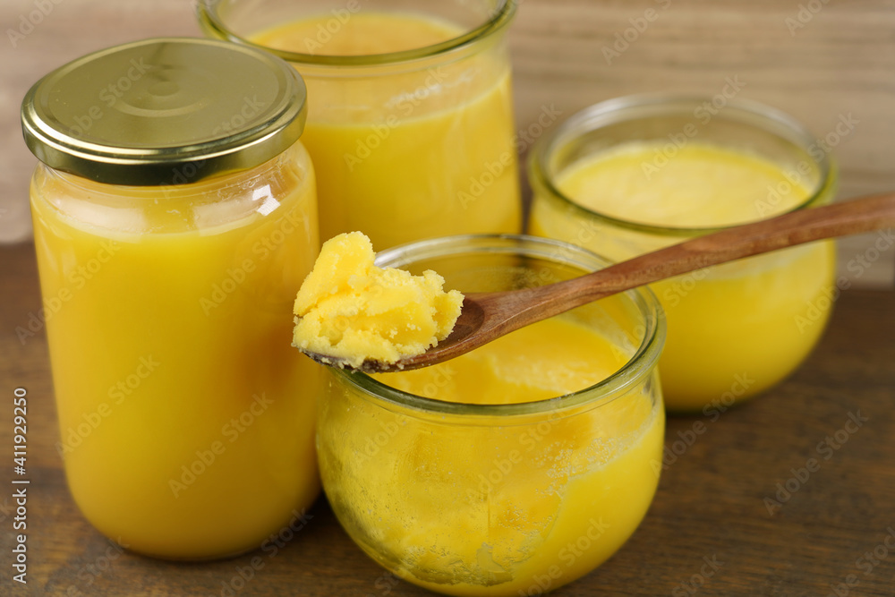 Homemade ghee (Sade yag) in jars and wooden spoon . Ghee is purified butter. Homemade ghee (Sade yag) in jars and wooden spoon . Ghee is purified butter.