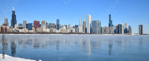 Big city skyline along frozen lakeshore in winter