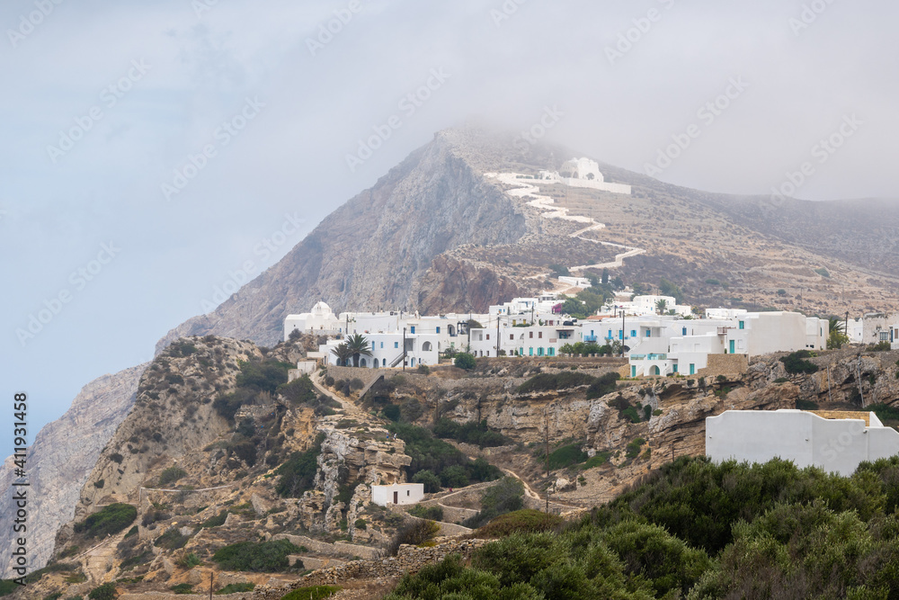 Folegandros Island. View of the city and the church on the top of the mountain. Hazy day. Cyclades, Greece
