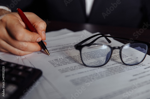 Bild auf Leinwand Person's hand sign documents at desk. Business concept.