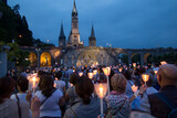Lourdes, France, 24 June 2019: Evening procession with candles at the shrine of Lourdes