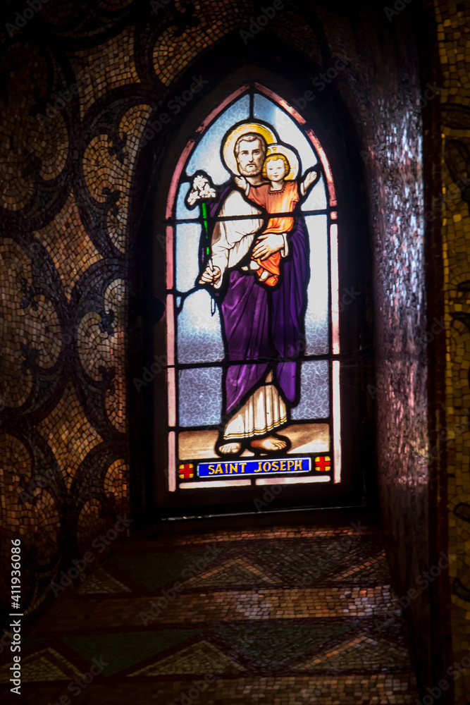Lourdes, France, 24 June 2019: Stained glass window in the Basilica of the Immaculate Conception in Lourdes, France