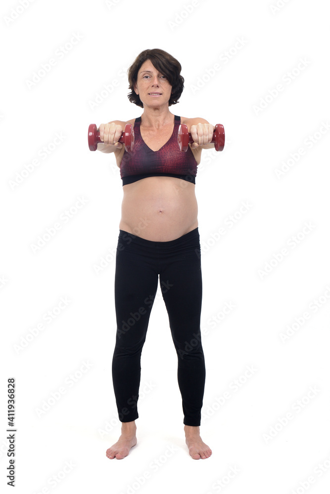 pregnant woman standing doing exercise dumbbells on white background pregnant woman standing doing exercise dumbbells on white background