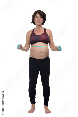 front view  of a pregnant woman standing doing exercise resistance bands on white background