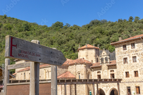 Wooden sign points to San Miguel Hermitage (Ermita de San Miguel) chapel near Santo Toribio de Liebana monastery, Potes, Picos de Europa mountains, Spain. photo