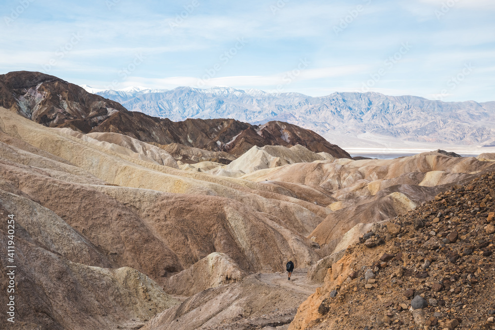 Hiker on trail at Zabriskie Point in Death Valley, California