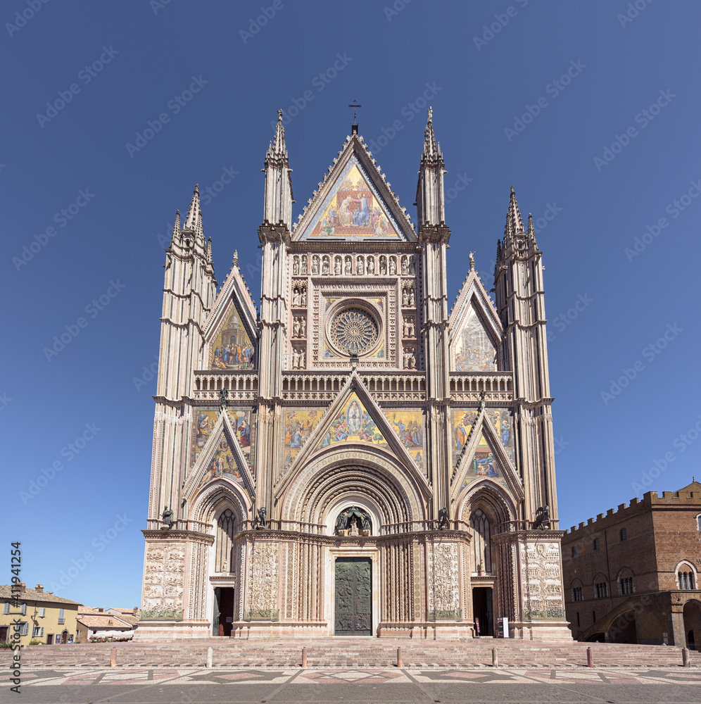 Renaissance facade of Orvieto cathedral, with rose window and gothic style spires and sculptures, a famous landmark in Orvieto medieval town in Umbria, Italy